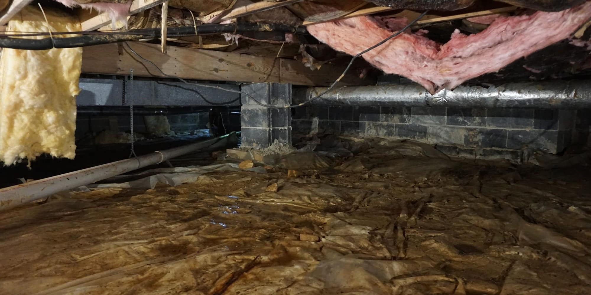 Standing water pooling inside a Florida crawl space