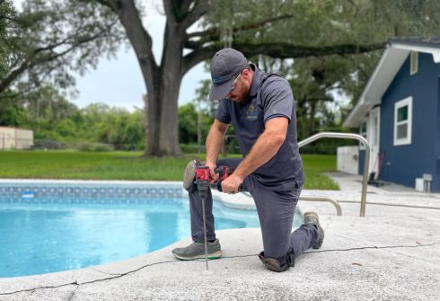 Repaired and leveled concrete driveway slab in front of a Florida home